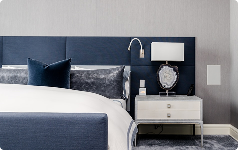 Elegant hotel room with blue bed and white furniture